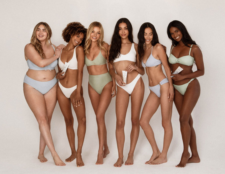 Diverse group of women in swimsuits holding Sonrei sunscreen